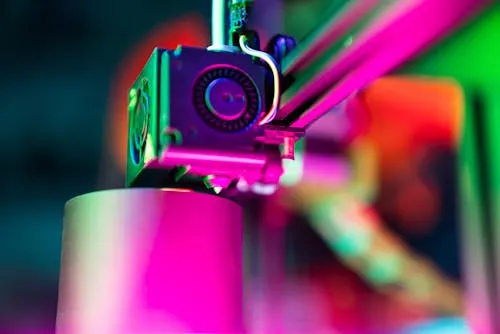 free photo of vibrant 3d printing close up in neon lighting